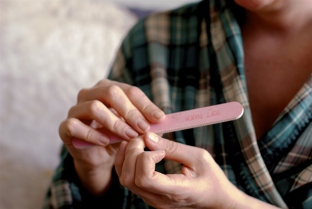 Woman filing her nails